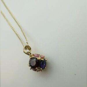 Elegant gold pendant necklace with pink and purple gemstones
